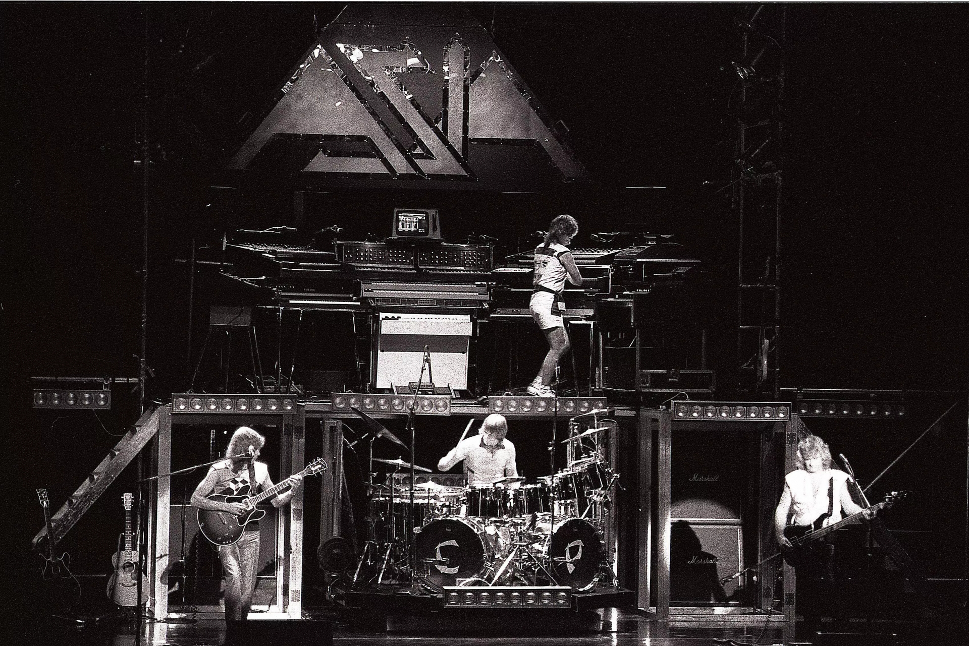 British arena rock supergroup Asia perform live in Germany in 1982 [L-R Steve Howe (guitar), Carl Palmer (drums), Geoff Downes (keyboards), John Wetton (bass, lead vocals).