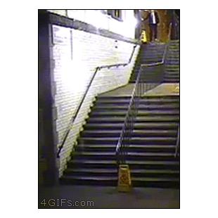 A drunk guy tries to walk down stairs
