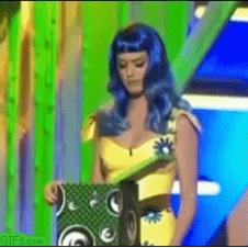 Katy Perry gets a surprise when she looks into a box.