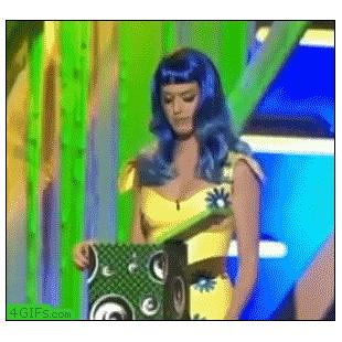 Katy Perry gets a surprise when she looks into a box.