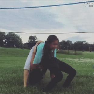 A girl trying gymnastics does a piledriver