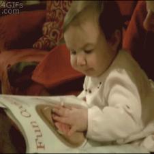 Baby eats from magazine.
