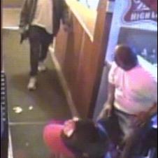 A bouncer elbows a man entering with a gun and chases him off.
