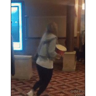 A clumsy girl spills all her popcorn while falling.