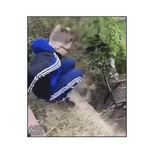 A kid jumps onto a glass table from a hill.