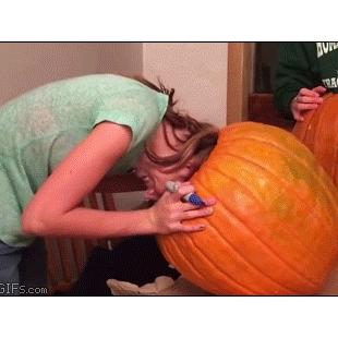 A girl gets her head stuck inside a pumpkin