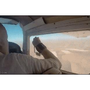 A man's cellphone gets sucked out of an open airplane window.