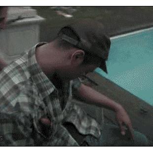 Friends prank a drunk guy passed out in a pool chair.