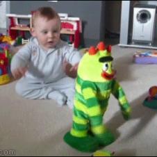 A baby has fun with a dancing toy.
