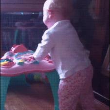 A startled baby falls over.