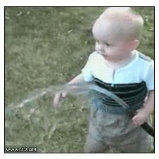 A toddler figures out a hose