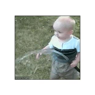 A toddler figures out a hose